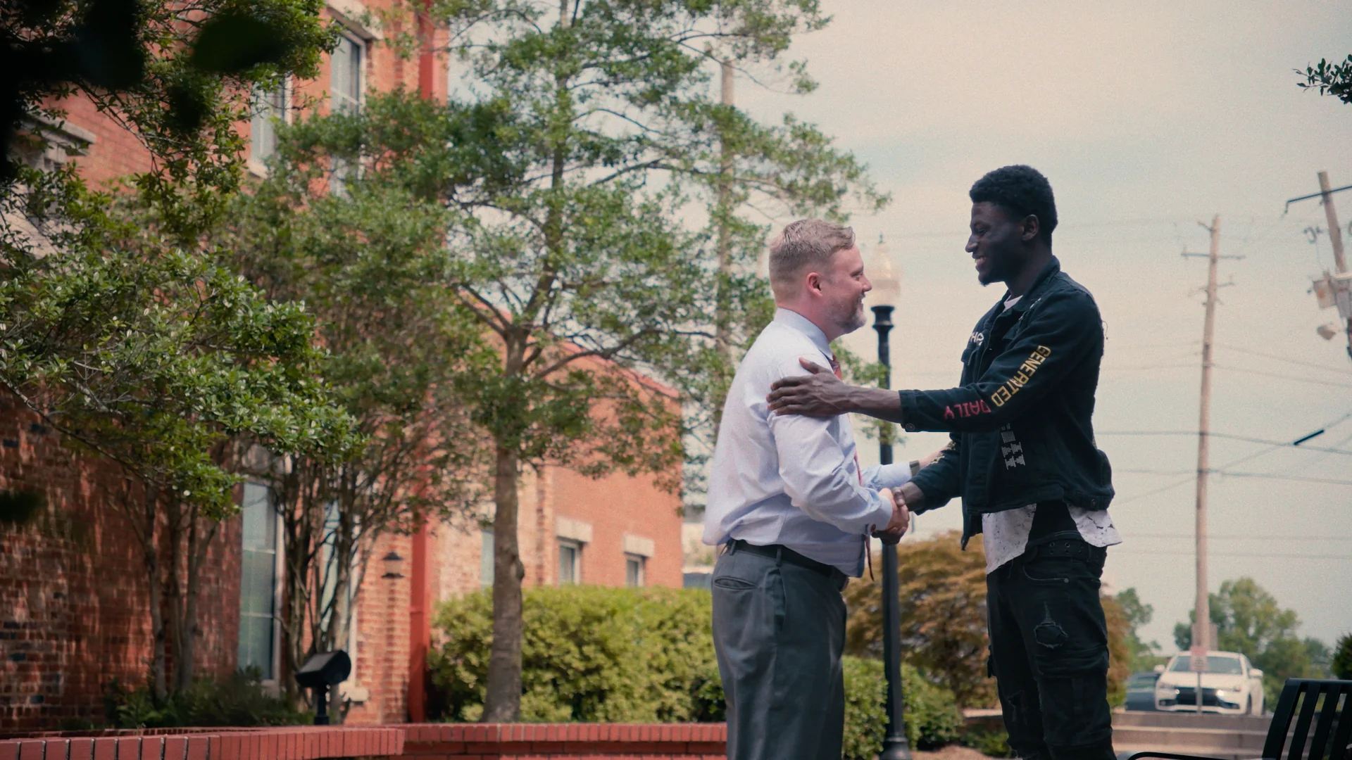 Attorney greeting a client outside during a law firm video scene