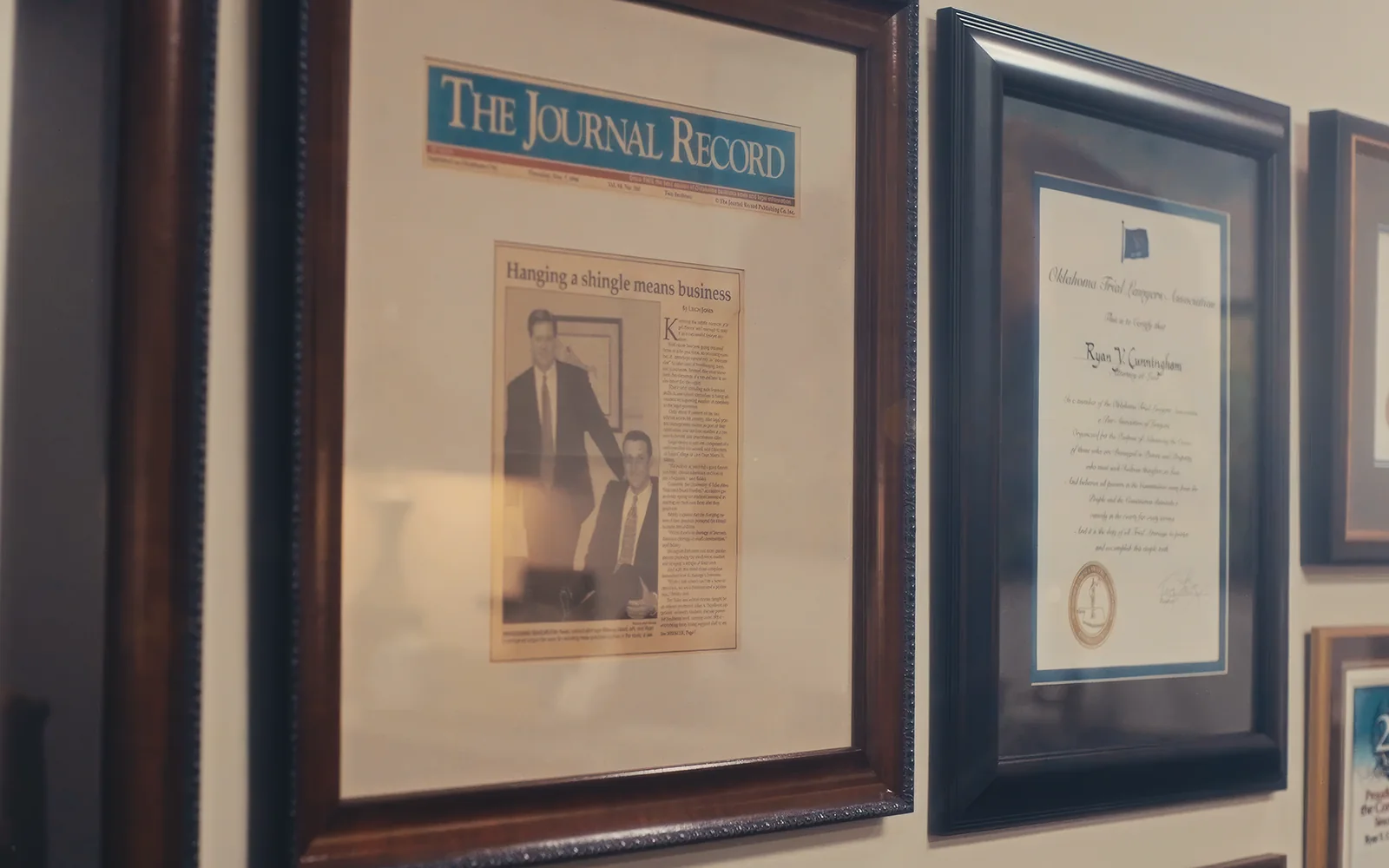 Framed law firm awards and press features used as evergreen brand video visuals