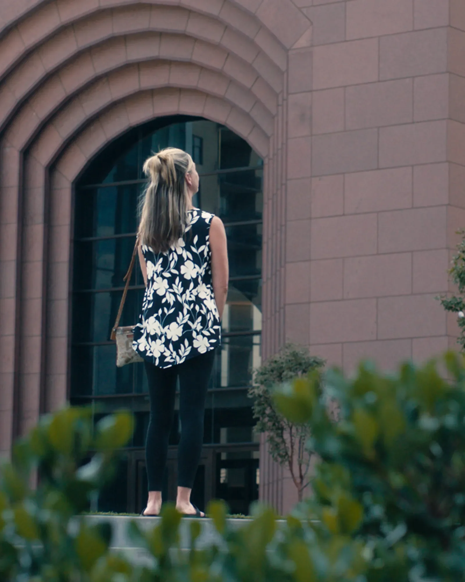 Client standing near a courthouse during a law firm testimonial video
